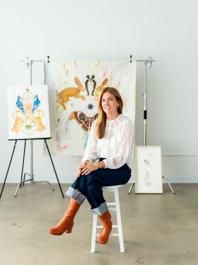 branding photo of an artist surrounded by her work. 