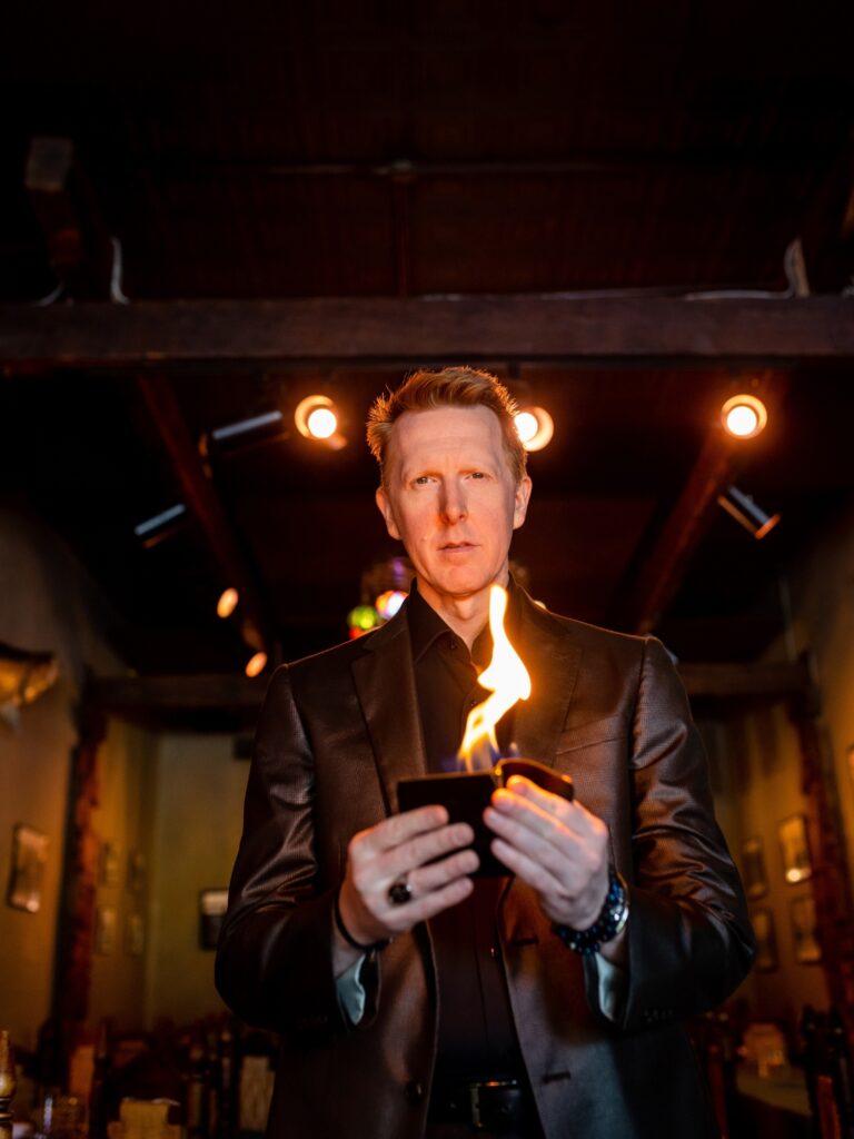 branding photo of magician doing a fire trick.